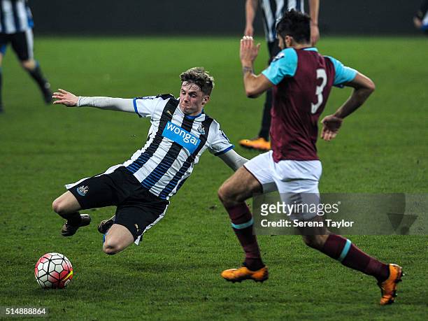 Craig Spooner of Newcastle slides to intercept the ball from Stephen Hendrie of West Ham United during the Barclays U21 Premier League Match between...