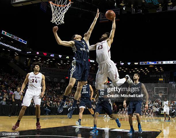DeAndre Bembry of the Saint Joseph's Hawks attempts a dunk against Yuta Watanabe of the George Washington Colonials in the quarterfinals round of the...
