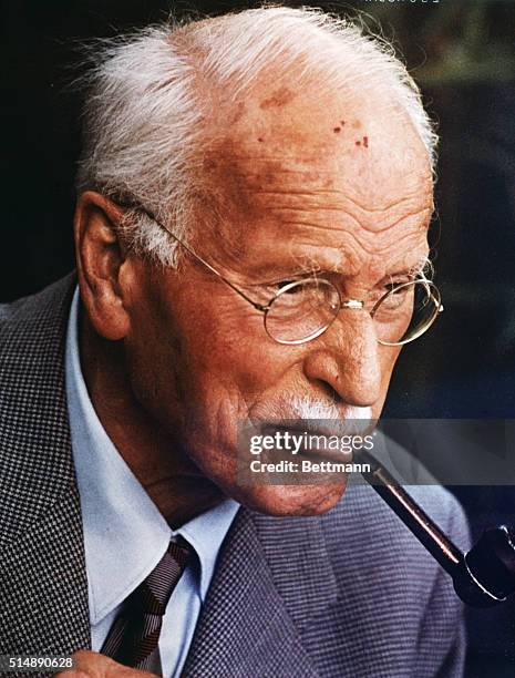 Swiss psychiatrist Carl Gustav Jung smoking a pipe. He is known as the founder of analytical psychology.