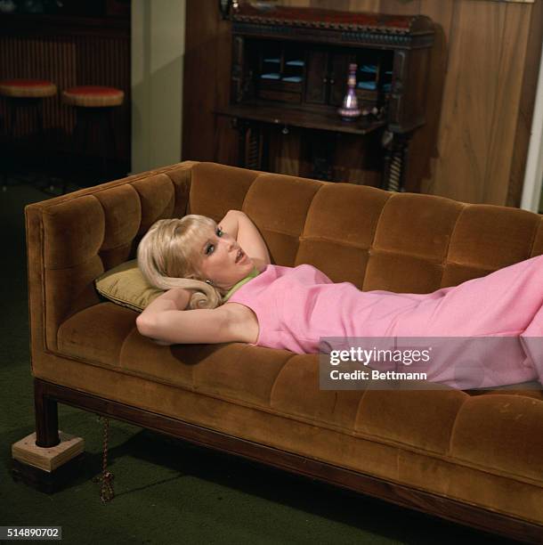 The star of I Dream of Jeanie, Barbara Eden, relaxes on sofa in a scene from the hit television series which ran from 1965-1970.