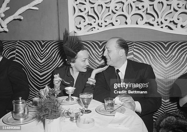 New York: Actress Gloria Swanson and escort, seated in zebra booth at Manhattan's elegant nightclub, El Morocco, 154 E. 54th Street, New York.