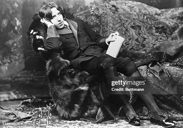 Oscar Wilde relaxing on the divan during his lecture trip through America.
