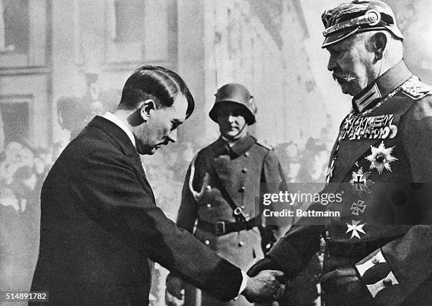 Hitler greets President Hindenburg with a handshake and a deferential bow of the head on "Potsdam Day", march 21, 1933.