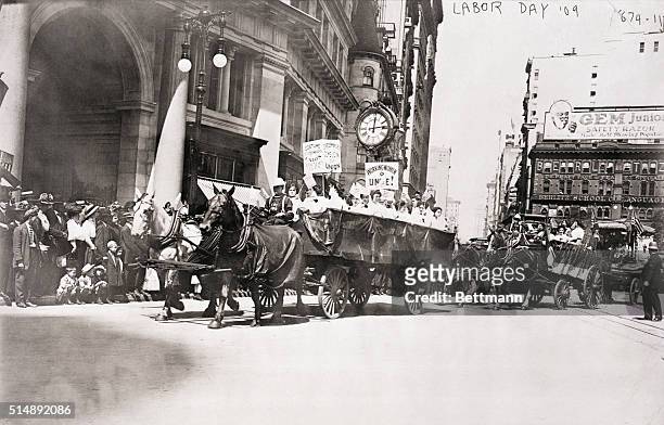 New York, NY: Workers of the International Ladies' Garment Workers' Union ride in horse-drawn carts during a Labor Day parade in New York City.