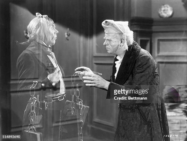 Reginald Owen, playing Scrooge, speaks with his dead business partner Marley, played by Leo G. Carroll, during the 1938 MGM production of "A...