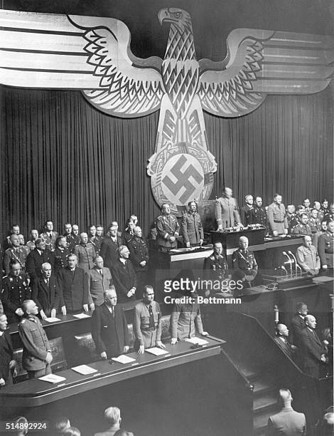 Herman Goering giving a speech to the Reichstag. In the foreground are Blomberg, Schwerin-Drosigk and Hitler.