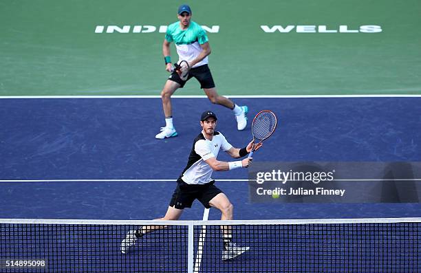 Andy Murray and Colin Fleming of Great Britain in action against Milos Raonic of Canada and John Isner of USA in the doubles during day five of the...