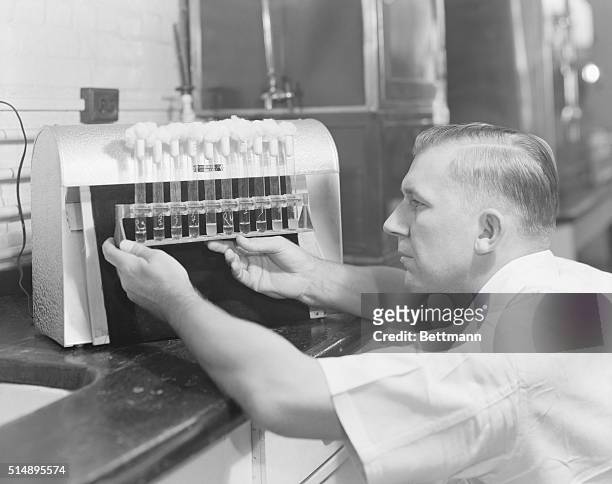 Penicillin manufacturer at Charles Pfizer factory testing cultures. Undated photograph.