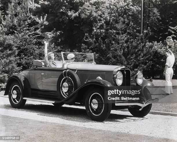 Studebaker President 8 Roadster. Girls waving to tennis player.