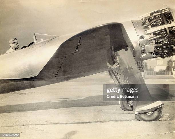 Howard Hughes, young film producer and aircraft enthusiast, is shown here settled in his new racer, in which he plans to compete in the Bendix...