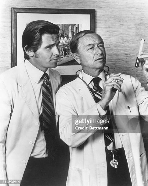 Robert Young, shown here with a colleague, looking at a test tube, stars as Dr. Marcus Welby, compassionate family practitioner and knowledgeable...