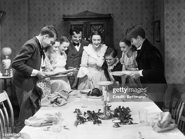 The Cratchit family at Christmas dinner in a scene from 'A Christmas Carol', directed by Edwin L. Marin, 1938. From third left, June Lockhart, Gene...