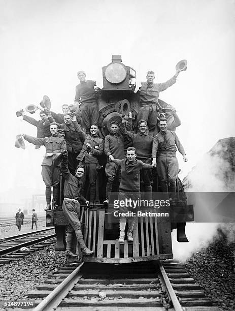 Picture shows the Mexican Expedition of 1916. US soldiers riding on the cowcatcher of an American locomotive.