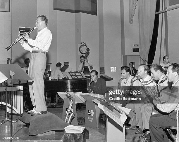 Woody Herman, Columbia Records star, leads the "Herd" as they make another hit recording in the Columbia Studios. It was Woody's smash hit "Caldonia"...