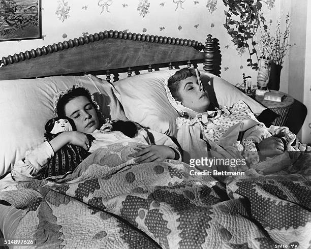 Margaret O'Brien and Elizabeth Taylor forget their troubles in dreams in this scene from M-G-M's charming Technicolor production of Louisa May...