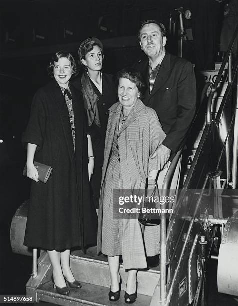 Walt Disney and his rarely photographed family arrived today from Los Angeles aboard an American Airlines flagship. Mr. Disney leaves for England...