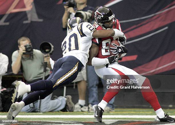 Dez White the Atlanta Falcons makes the game-winning touchdown catch under pressure from Jerry Wilson of the San Diego Chargers on October 17, 2004...