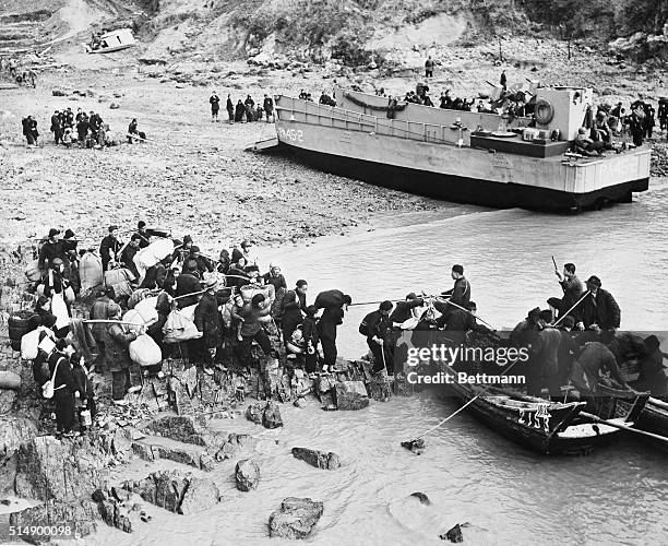 As part of Operation Pullback, Chinese Nationalist civilians bring as much of their belongings as they can carry to be loaded onto sampans to be...