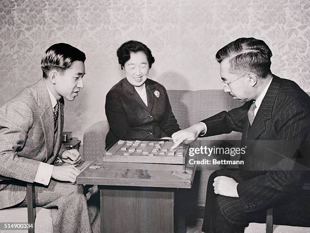 Crown Prince Akihito, , of Japan, who had just turned 21, gets better acquainted with his father Emperor Hirohito, over a game of Shogi, or Japanese...