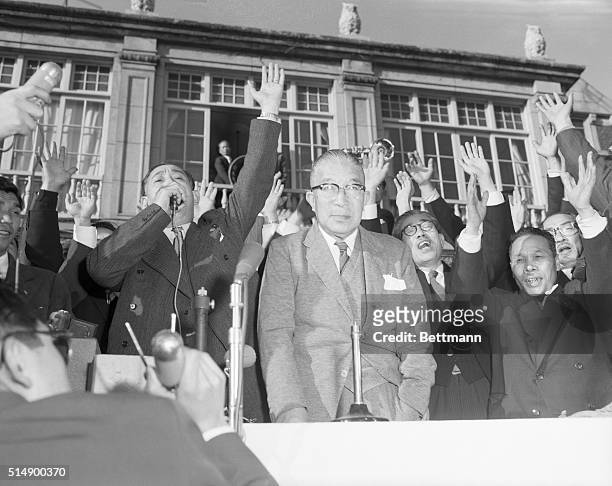 Japanese Prime Minister Ichiro Hatoyama smiles triumphantly as members of his Democratic Party congratulate him on the election results. Under his...