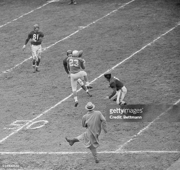 George Halas, owner coach of the Chicago Bears, jumps for joy as John Helwig breaks up as pass intended for Detroit Lions' Jug Girard during a pro...