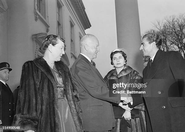 President and Mrs. Eisenhower welcome Reza Pahlevi Shah of Iran, and his wife, Queen Soraya, who arrive for lunch at the White House. The royal...