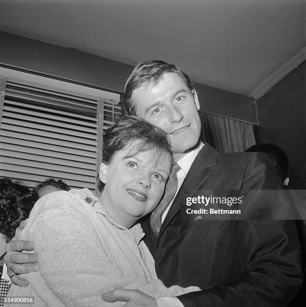 Actor Roddy McDowall, currently co-starring in the Broadway hit, Camelot, stops off backstage to congratulate entertainer Judy Garland, after her...