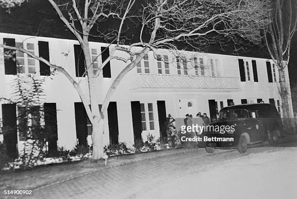 Star's Home in Murder Spotlight. Beverly Hills, California: Newsmen and the coroner's van stand outside the Beverly Hills home of actress Lana...