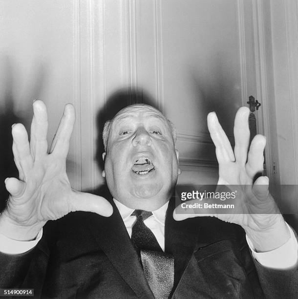 British director Alfred Hitchcock vamps for the camera as he appeared in Paris to present his new thriller, Psycho.