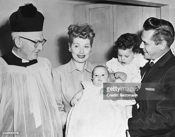 Left to right are Father Michael Hurley, Lucille Ball, Desiderio Alberto Arnaz IV, baby who was christened Lucie Desiree Arnaz, and Desi Arnaz.