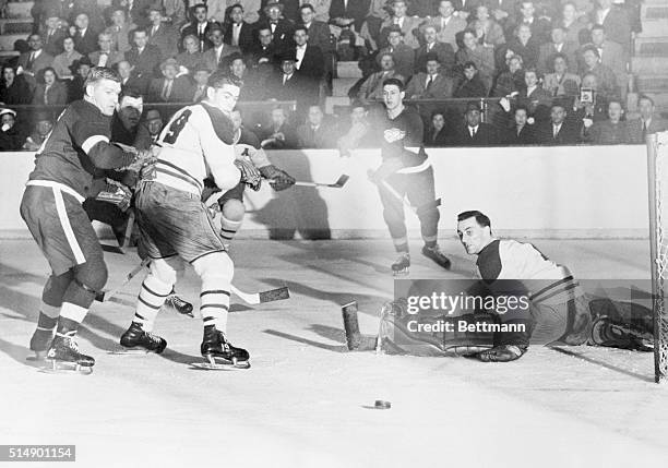 Canadian Save. Montreal, Canada: Montreal goalie Jacques Plante sits on the ice after deflecting Johnny Wilson's shot in tonight's Stanley Cup game...