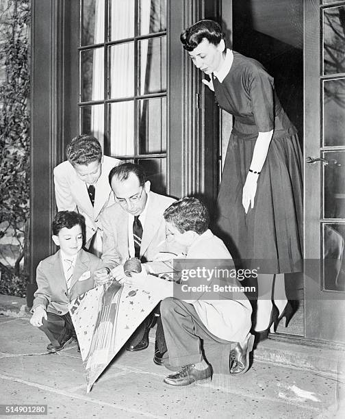 Polio Conqueror Plays With Sons: Ann Arbor, Michigan: Dr. Jonas Salk mends a kite with his three sons shortly before the historic University of...