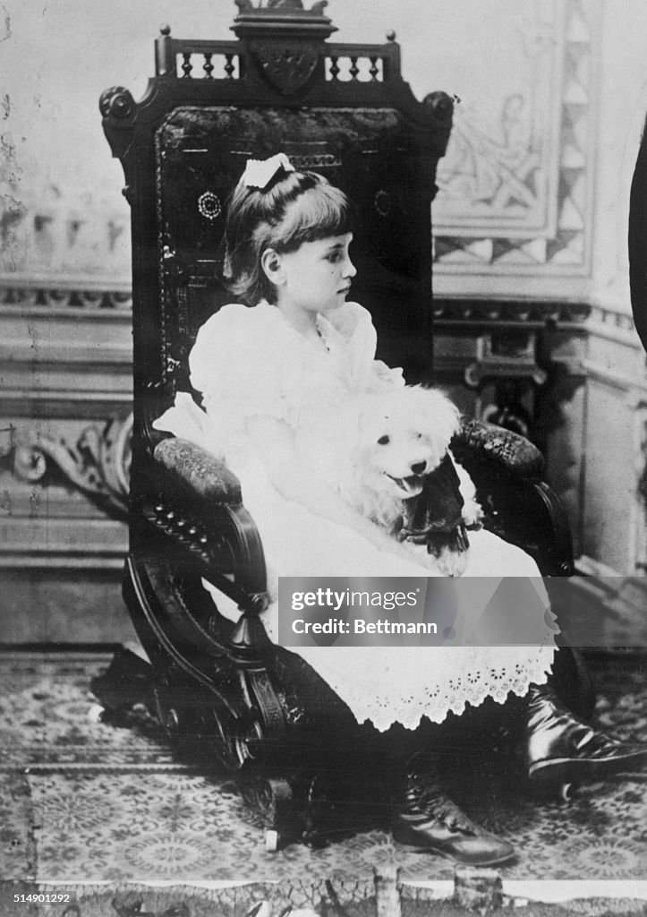 Helen Keller Holding Pet Poodle in Chair