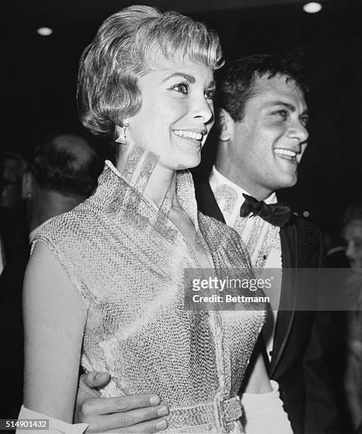 April 4 Hollywood, California: Actor Tony Curtis and his wife, Janet Leigh, who participated in the Academy Awards presentations today, sparkle at...