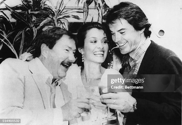 Robert Urich and Barbara Stock toast writer Robert Parker at a party they threw at a fancy Los Angeles restaurant before departing to Boston for...