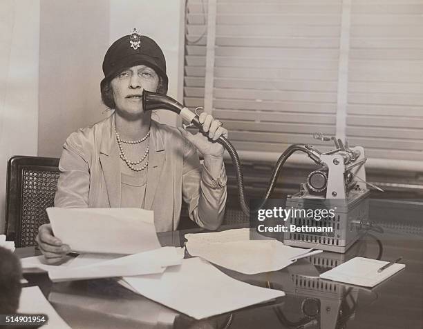 Lady Astor, British parliamentarian, reading from a brief into a dictaphone device.