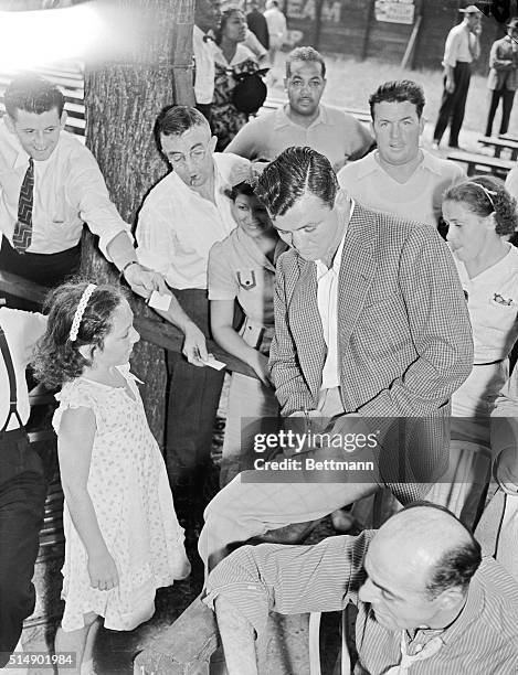 Jim Braddock, former heavyweight champion, signing autographs for the fans as he paid a visit to Joe Louis training camp at Pompton Lakes, N.J.,...