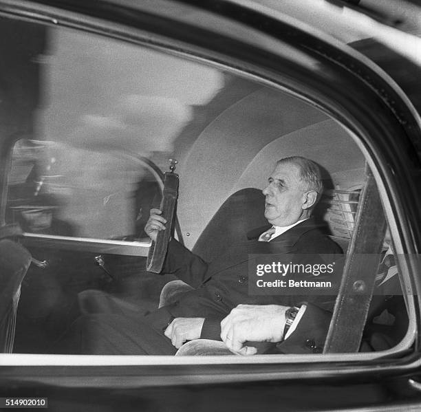 General Charles de Gaulle arrives at his former headquarters in Paris while France's new premier, Pierre Pflimlin warns that the country may be "on...