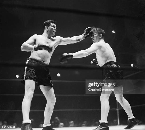 Jim Braddock flicks Tommy Farr with a right during their ten round bout at Madison Square Garden, January 21, 1938. Farr's right fell short. On the...