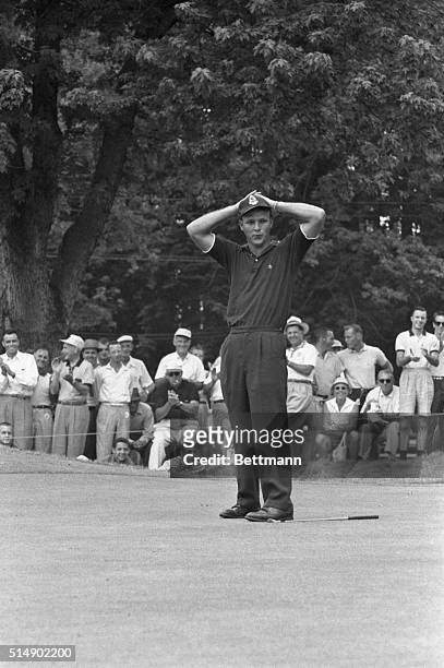Arnold Palmer makes a 20 foot putt on the 17th hole of the second round of the 1958 PGA Tournament, at Llanerch Country Club. Palmer, waiting for his...