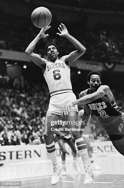 Sixers' Julius Erving has trouble rebounding the basketball as he plays against Milwaukee Bucks' Junior Bridgeman in third quarter action in their...