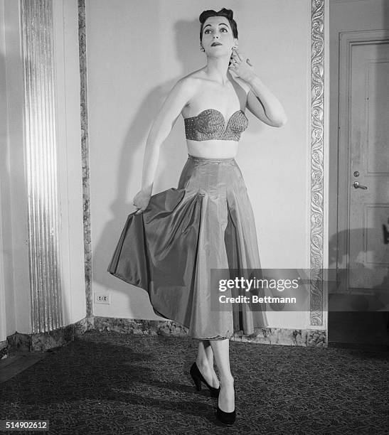 New York, NY: Three of the latest in fashion for millady as seen at the Waldorf Astoria at the Spring and Summer, 1951 Fashion show presented by the...