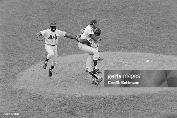 New York, NY: Met third baseman Ed Charles jumps with joy as pitcher Jerry Koosman and catcher Jerry Grote hug each other after the New York Mets...