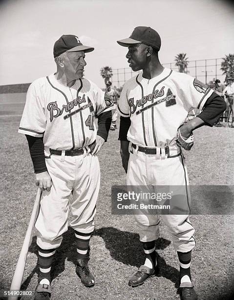 Charley Grimm and Hank Aaron chatting during a pause in action.