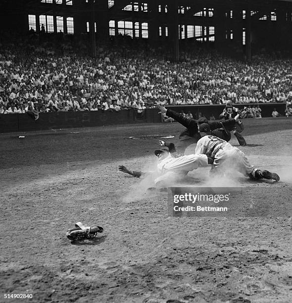 Cleveland, OH: Safe! says umpire Art Passarella as Indians' Lou Bourdeau slides safely to home in last of seventh inning in Cleveland Indians-New...