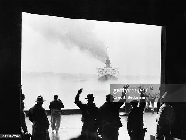 New York: This unusual photo captures the unreal feeling that permeated the North River pier today when the liner Queen Mary set sail for Europe....