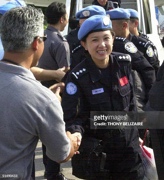 Chinese police are welcomed upon their arrival 17 October 2004 in Port-au-Prince from Beijing to reinforce the police component of the United...