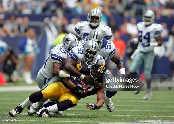 Duce Staley of the Pittsburgh Steelers is tackled by Al Singleton, Tyrone Williams and Dexter Coakley of the Dallas Cowboys in the first quarter at...