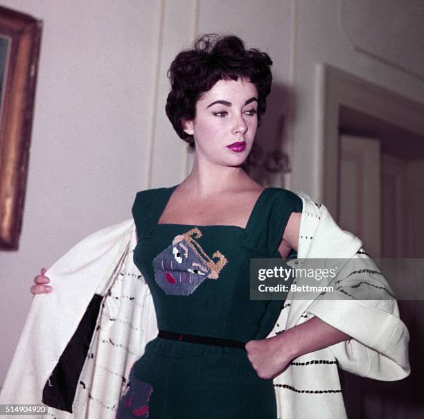 Rome, Italy: Elizabeth Taylor visits Fontana sisters salon in Rome. Here she is modeling a blue silk dress entitled "Mask."