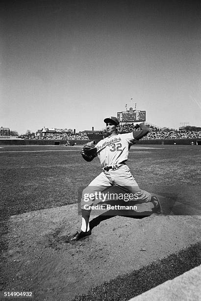 Chicago, IL: Los Angeles Dodger Sandy Koufax shows winning form as he throws during a game with the Chicago Cubs. Koufax struck out 18 Chicago Cubs...